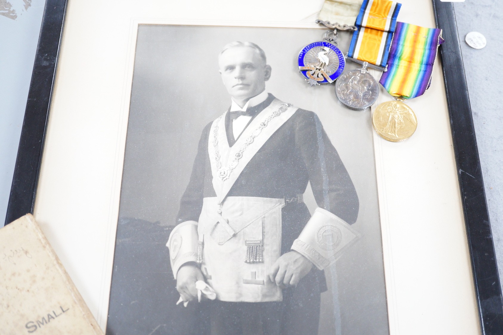 A WWI pair, silver masonic medal and soldier's small book